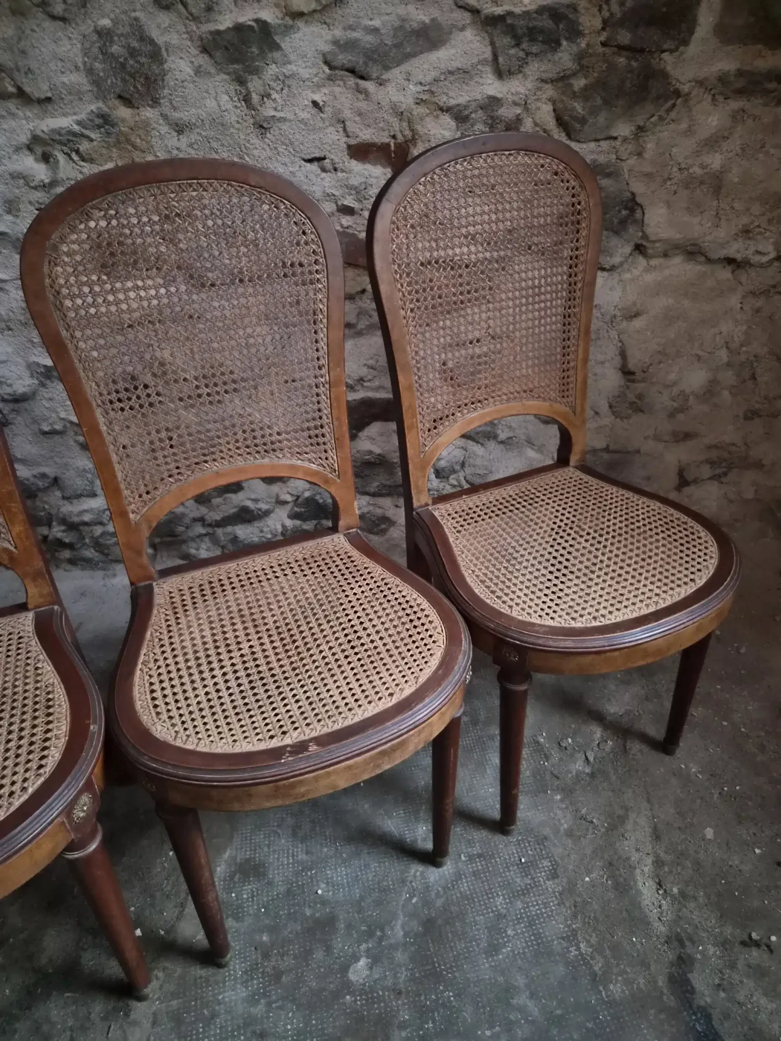 Set of 6 antique Louis XVI style dining chairs with caning.