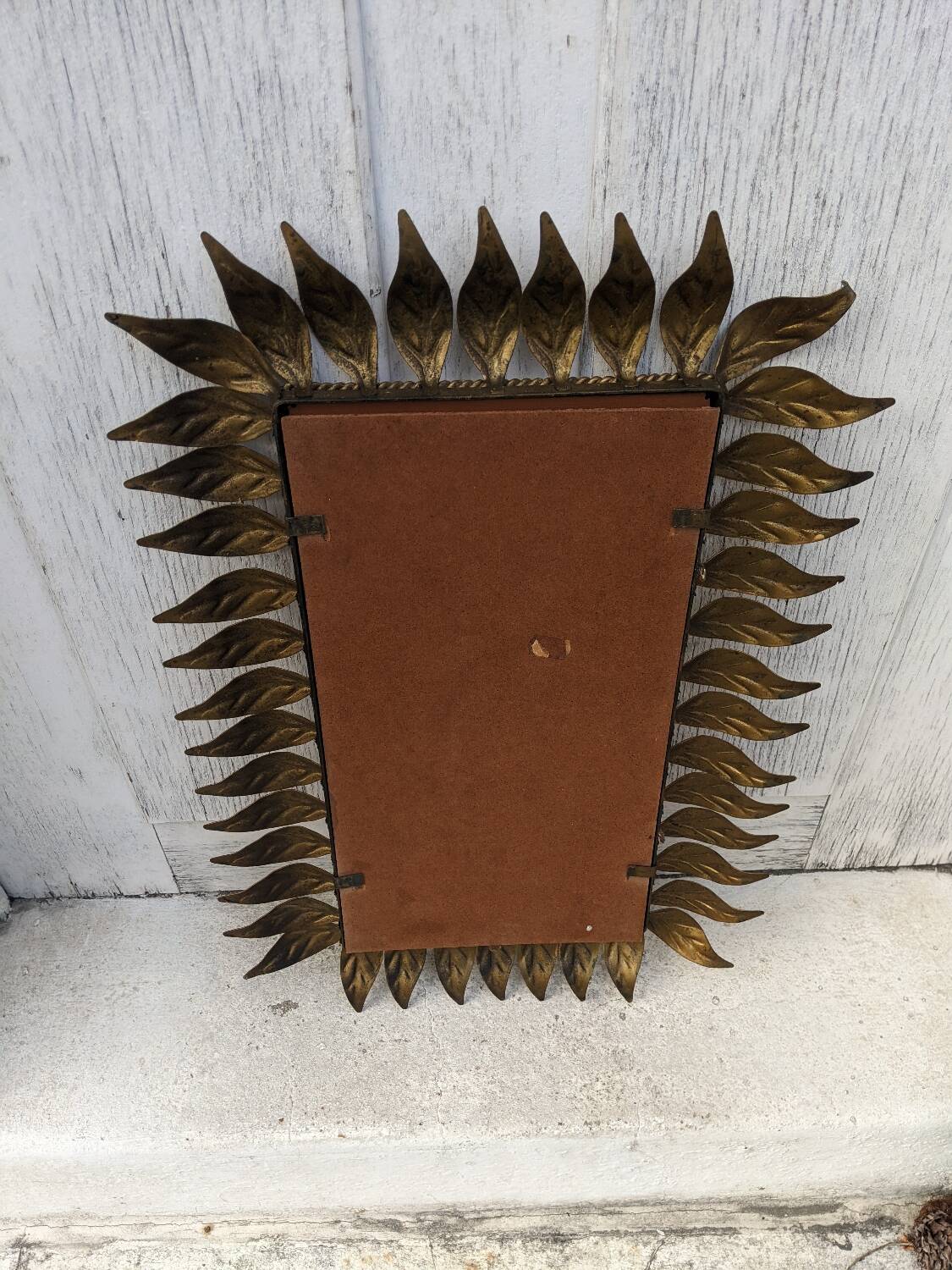 Vintage gold metal mirror with leaves from the 1950s.