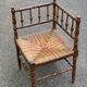19th-century solid wood corner chair with red and blue rush seating.