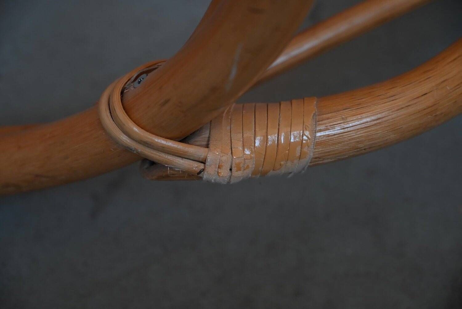 Vintage rocking chair in rattan from the 60s-70s, high openwork backrest.