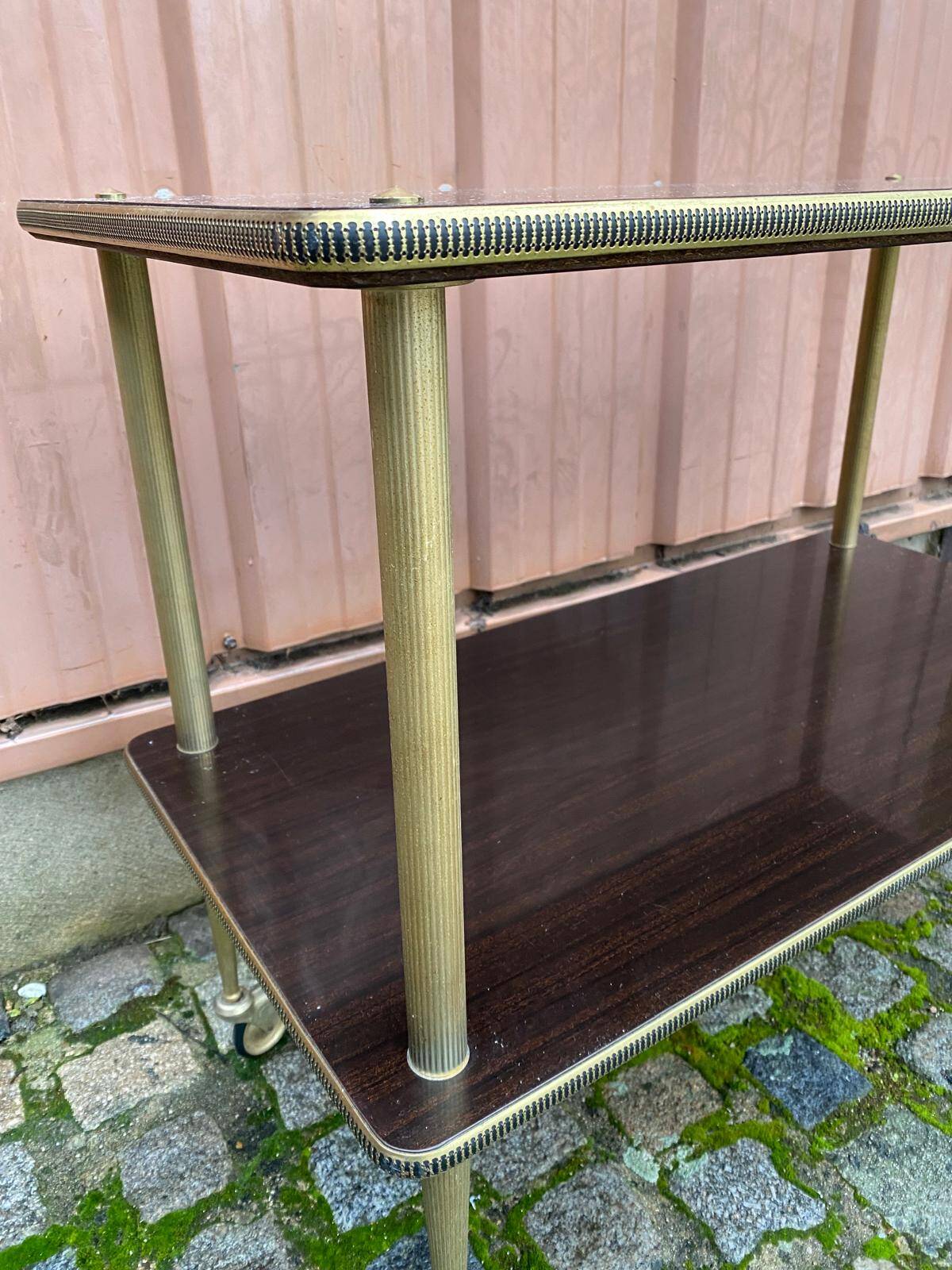 Brown rosewood rolling table with gold fluted legs