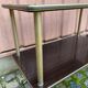 Brown rosewood rolling table with gold fluted legs