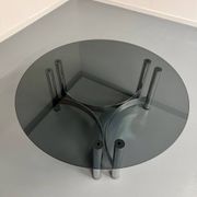 Round coffee table in smoked glass and chrome steel, 1970s design.