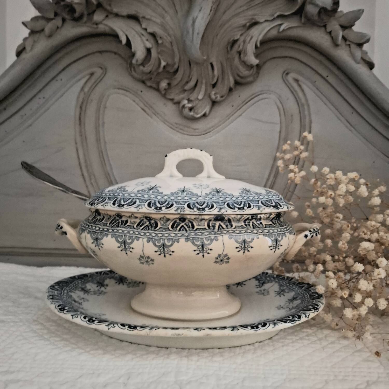 Antique iron earthenware sauceboat on a frame