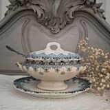 Old iron earthenware sauce boat on frame