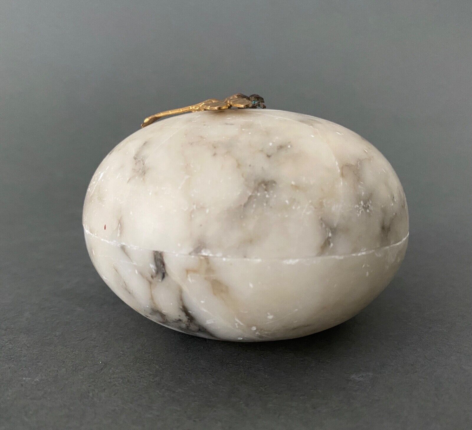 1900 alabaster ball shaped box surmounted by a golden dragonfly