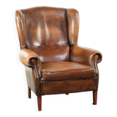 Wingback armchair made of sheepskin leather finished with decorative nails