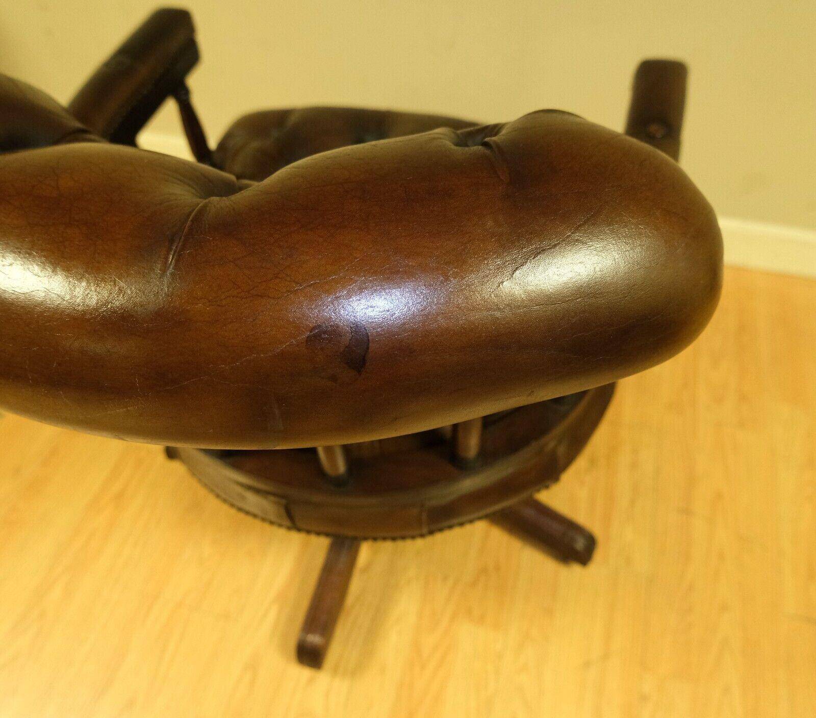 Restored Chesterfield captain's armchair in leather with an oak frame.