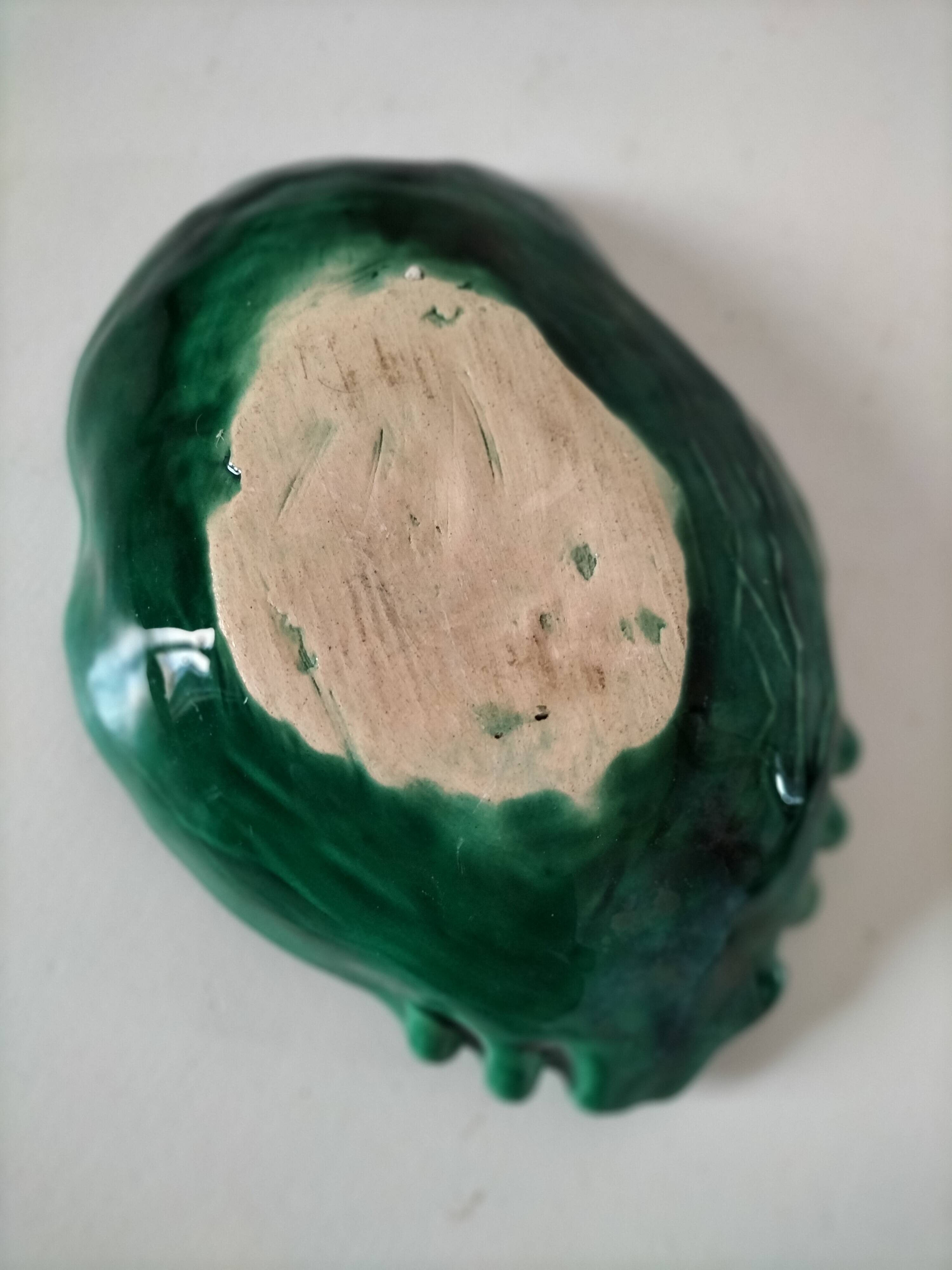 Vintage green slipware bowl in the shape of a cabbage leaf.