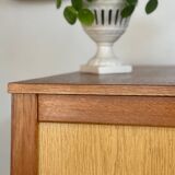 Vintage 1960s chest of drawers with covered handles.