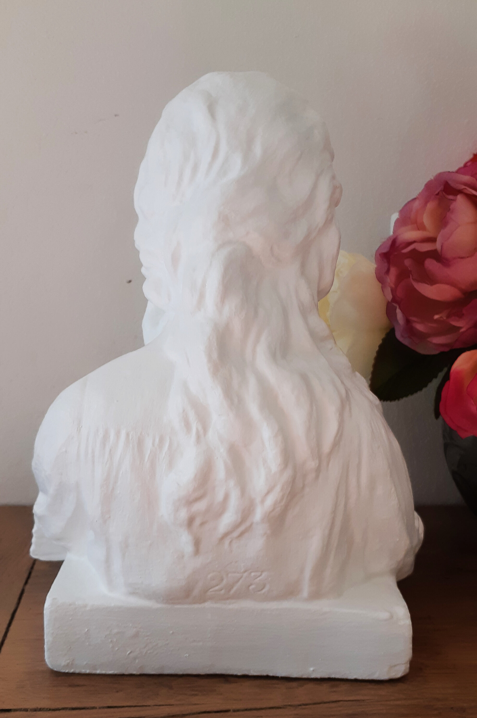 Plaster bust reading child