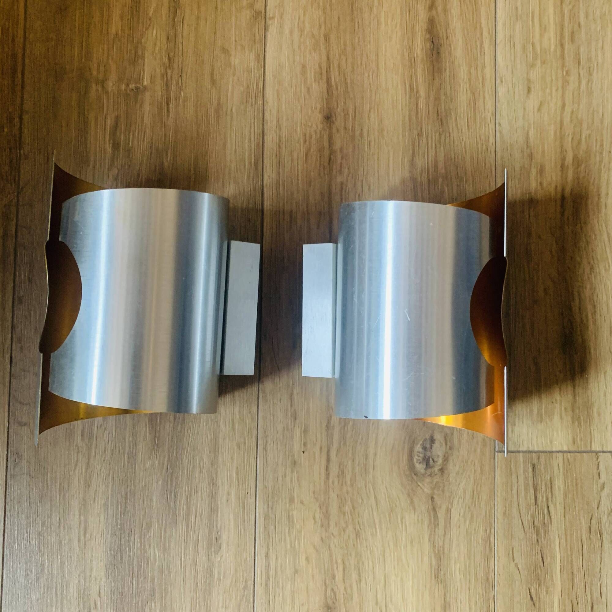 Pair of Space Age wall lights in brushed metal with a copper-orange interior.