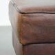 Sturdy vintage sheepskin ottoman in a beautiful large size with black piping