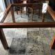 Table merisier plateau verre arbalète Roche Bobois