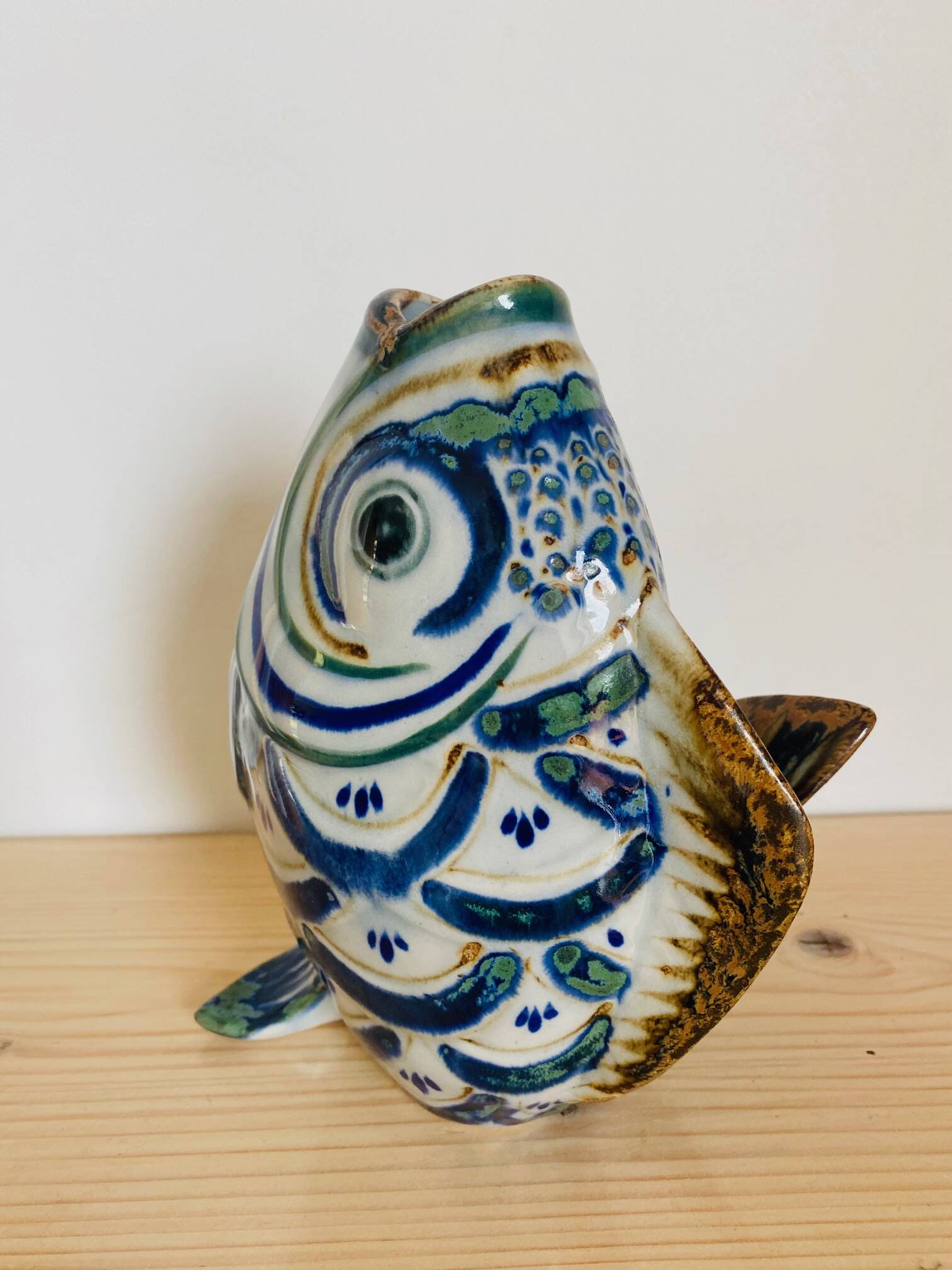 Blue ceramic zoomorphic vase in the shape of a poison.