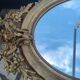 Ovoid mirror with double gilt pediments, circa 1830, 105x66 cm