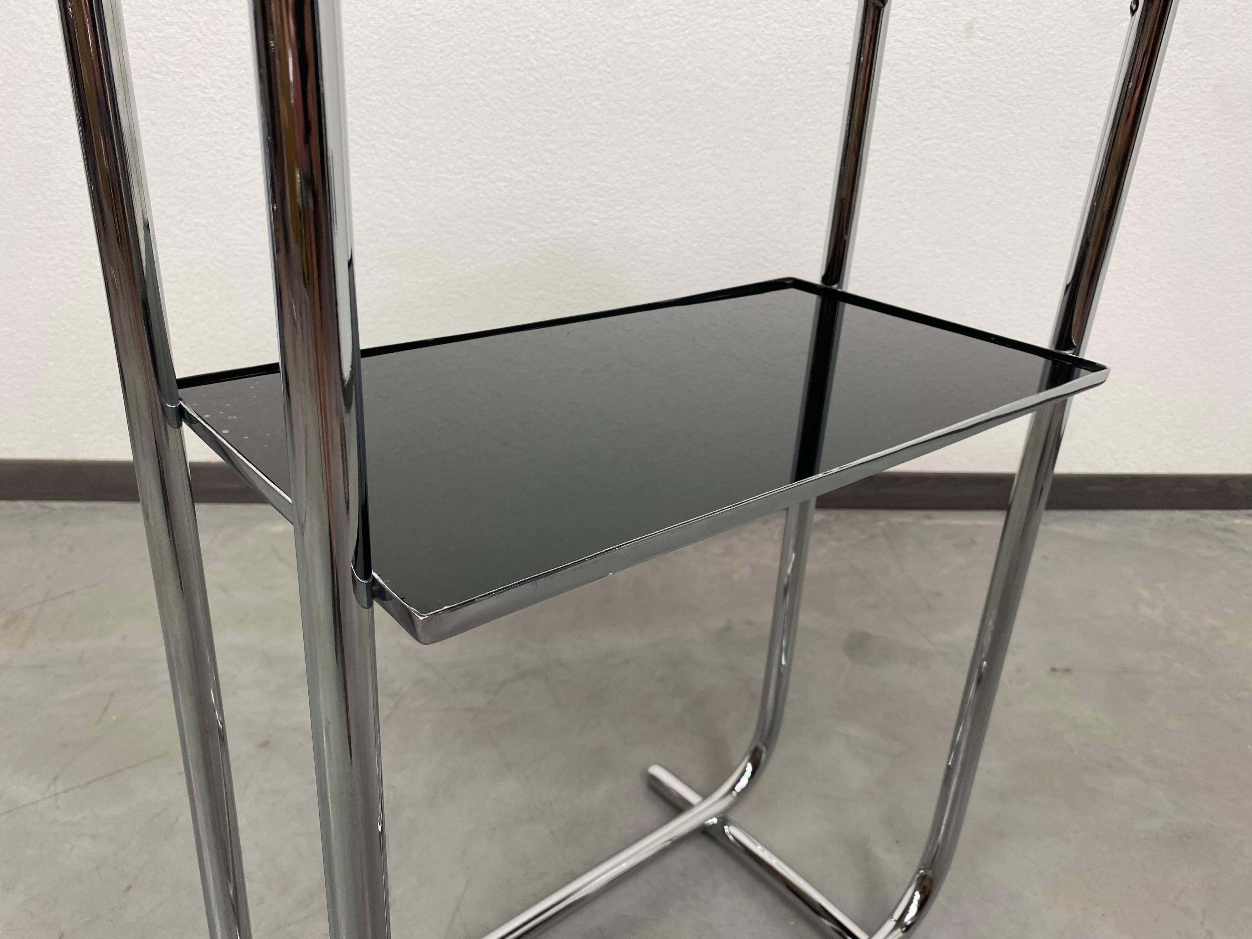 Bauhaus side table with a black glass top