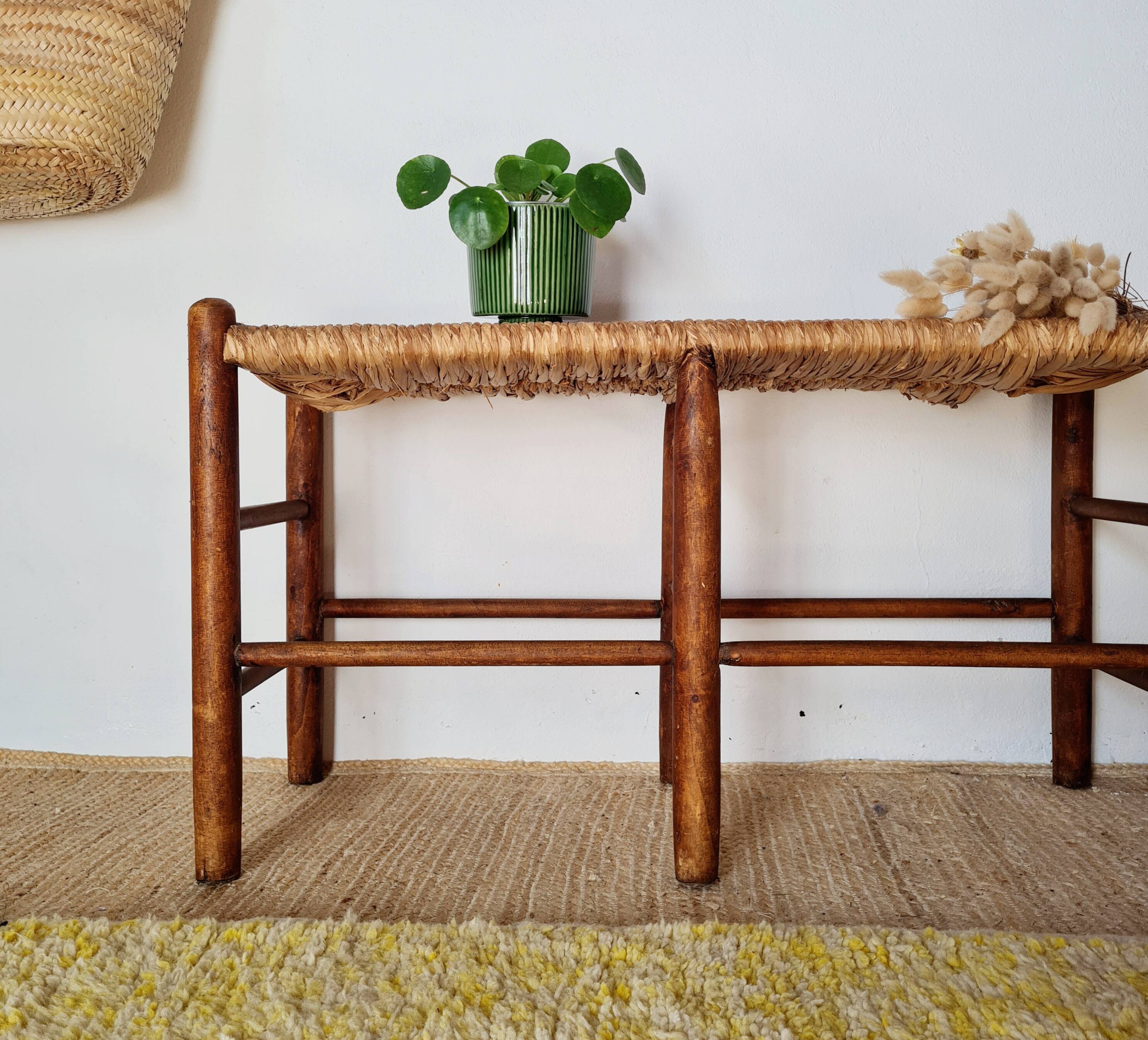 Old wooden and straw bench