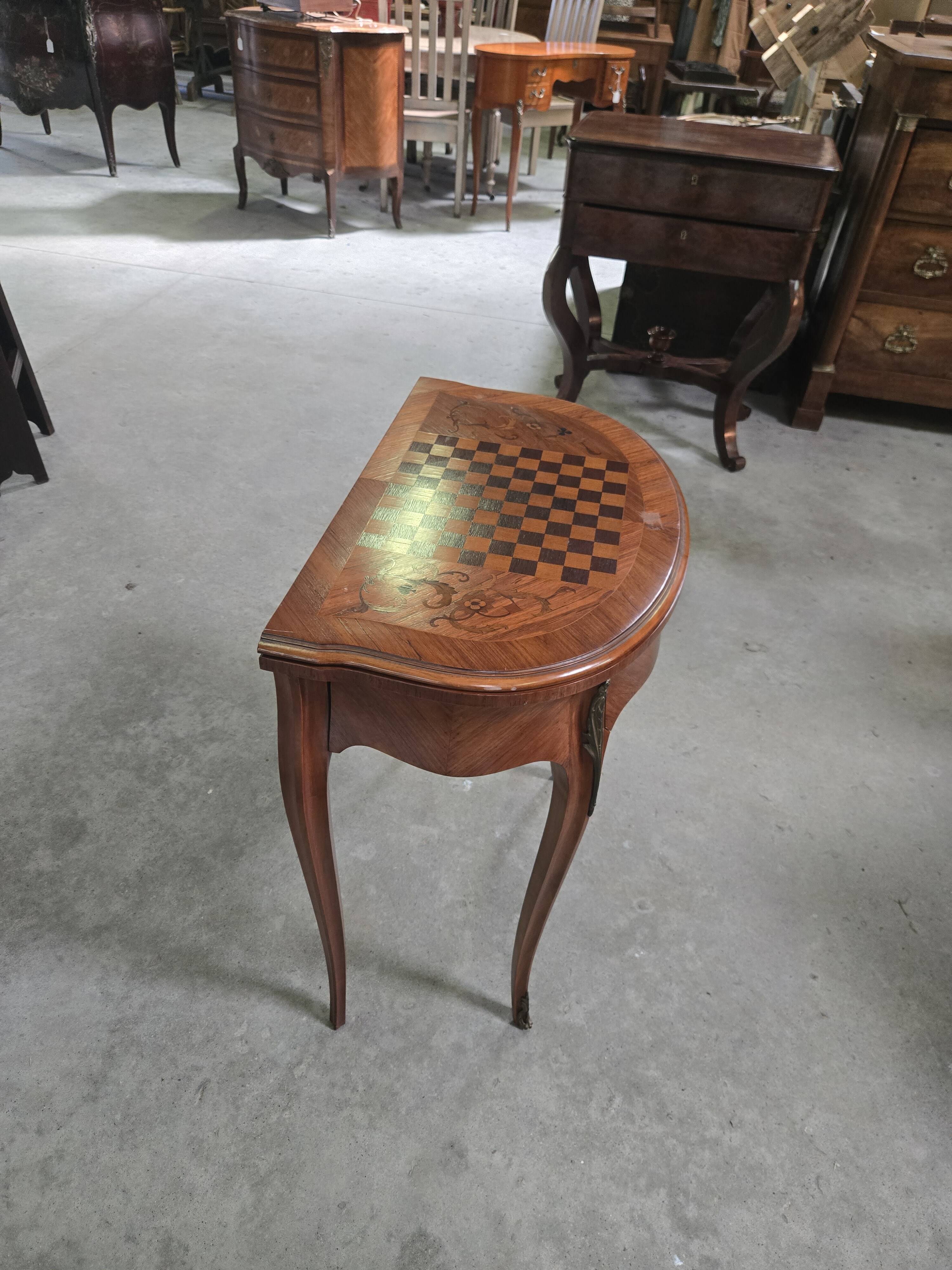 Half-moon gaming table in Louis XV style, made of precious wood marquetry.