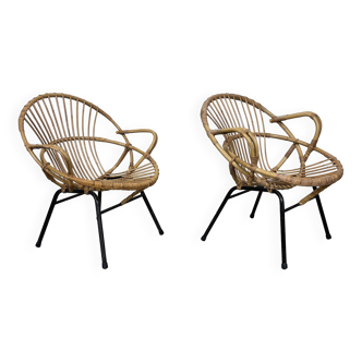 Pair of rattan armchairs with black steel base