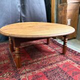 Round oak coffee table with drop leaves and turned legs