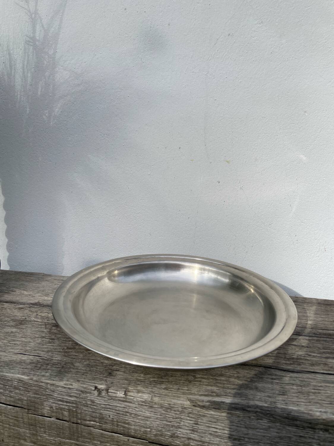 Round silver-plated metal serving dish with hallmark