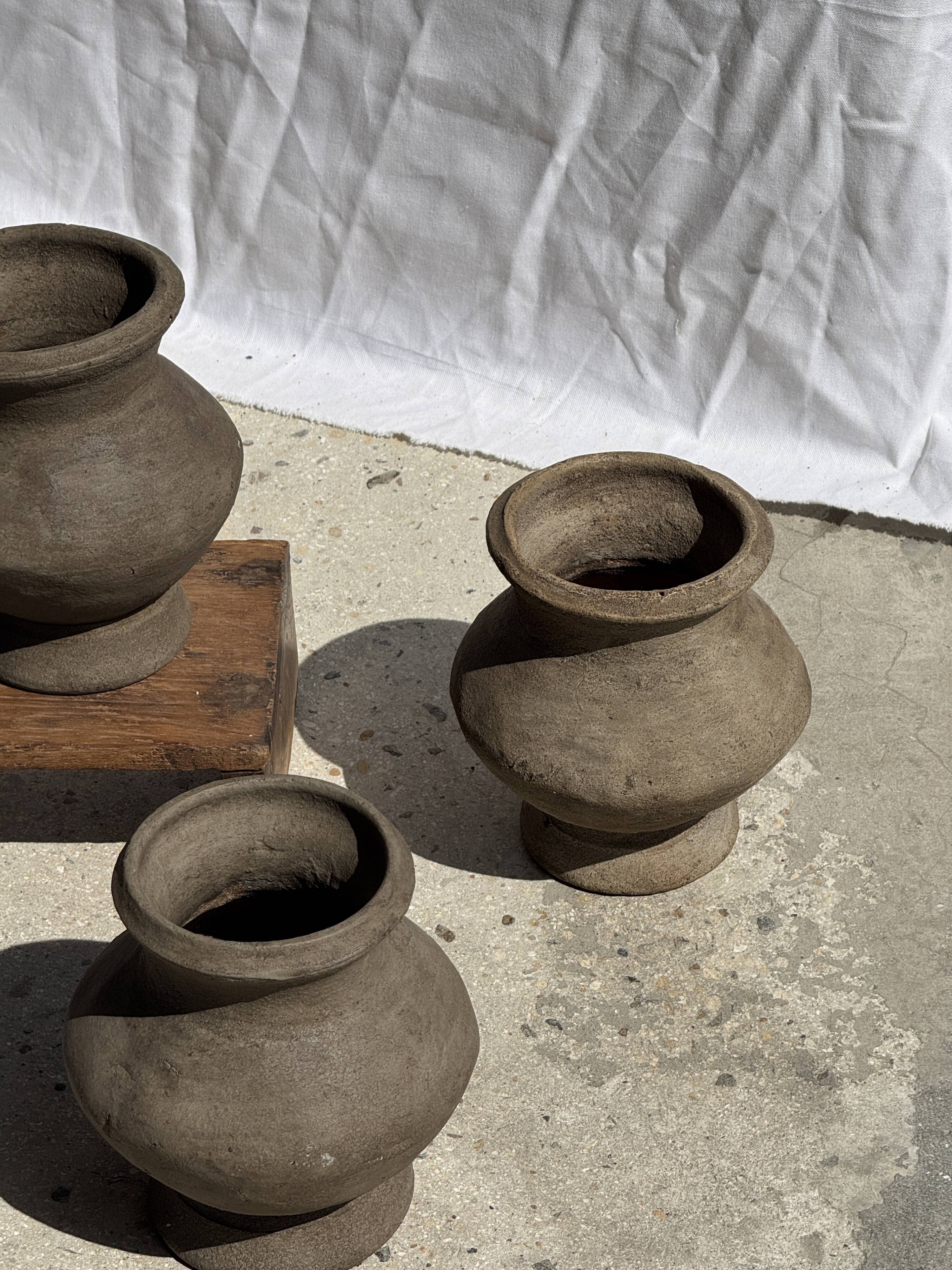 Small brutalist handcrafted terracotta vase with a pedestal, Indonesian, H19 D17.