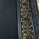 19th-century mirror Napoleon III in blackened wood on a gold background.