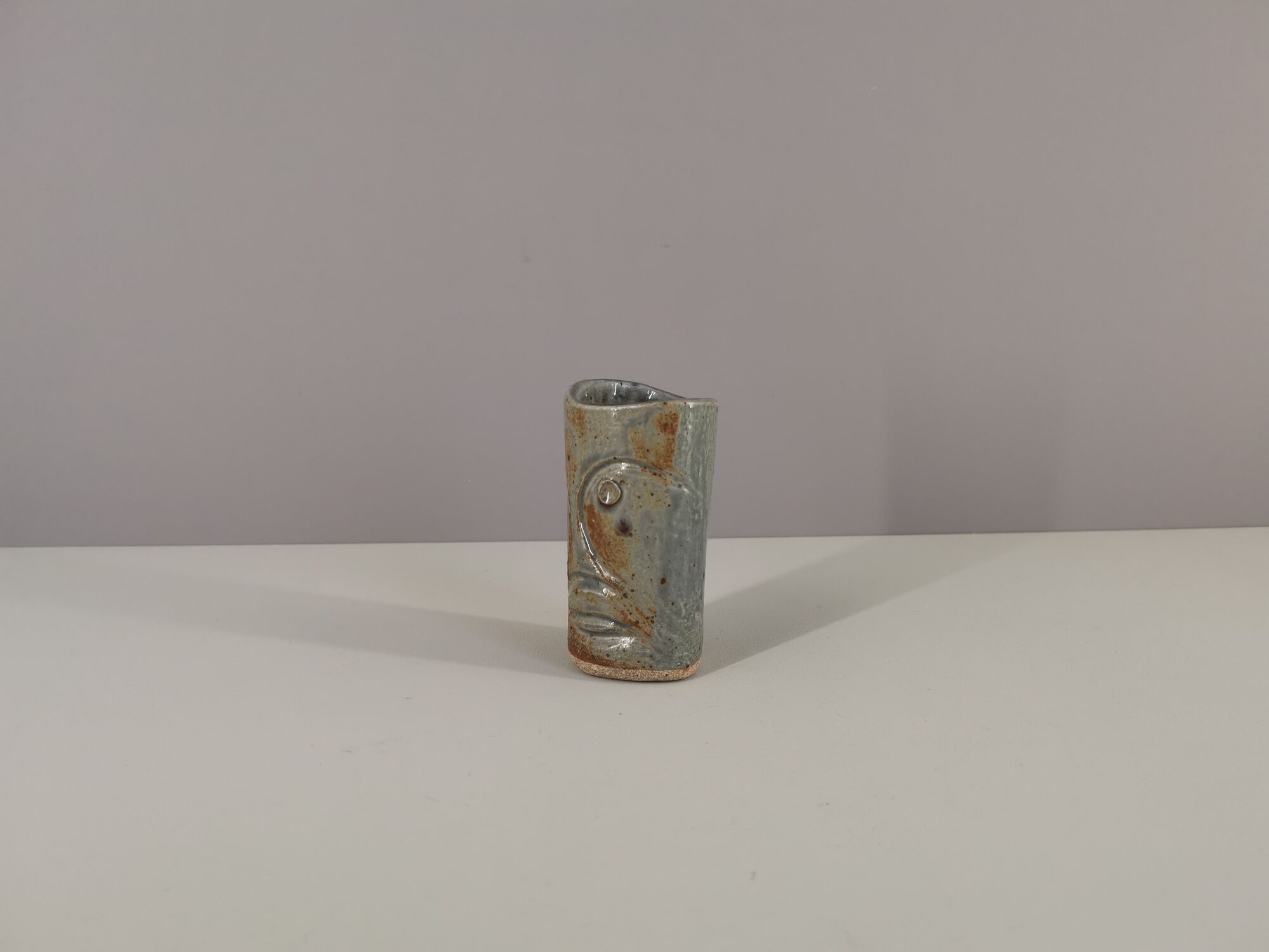 Signed vase in enamelled sandstone with stylized face