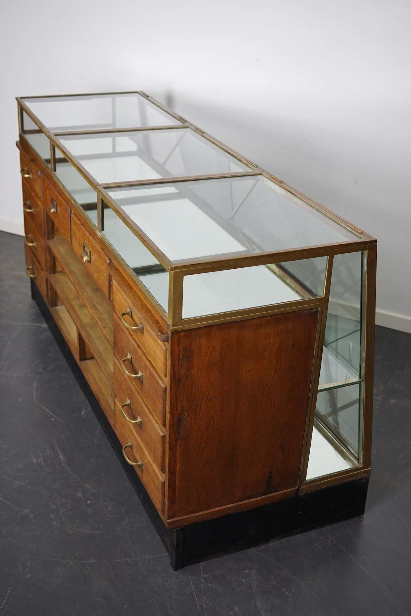Counter or shop window in oak glass and brass France around 1920