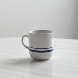 White ceramic cups with blue borders.