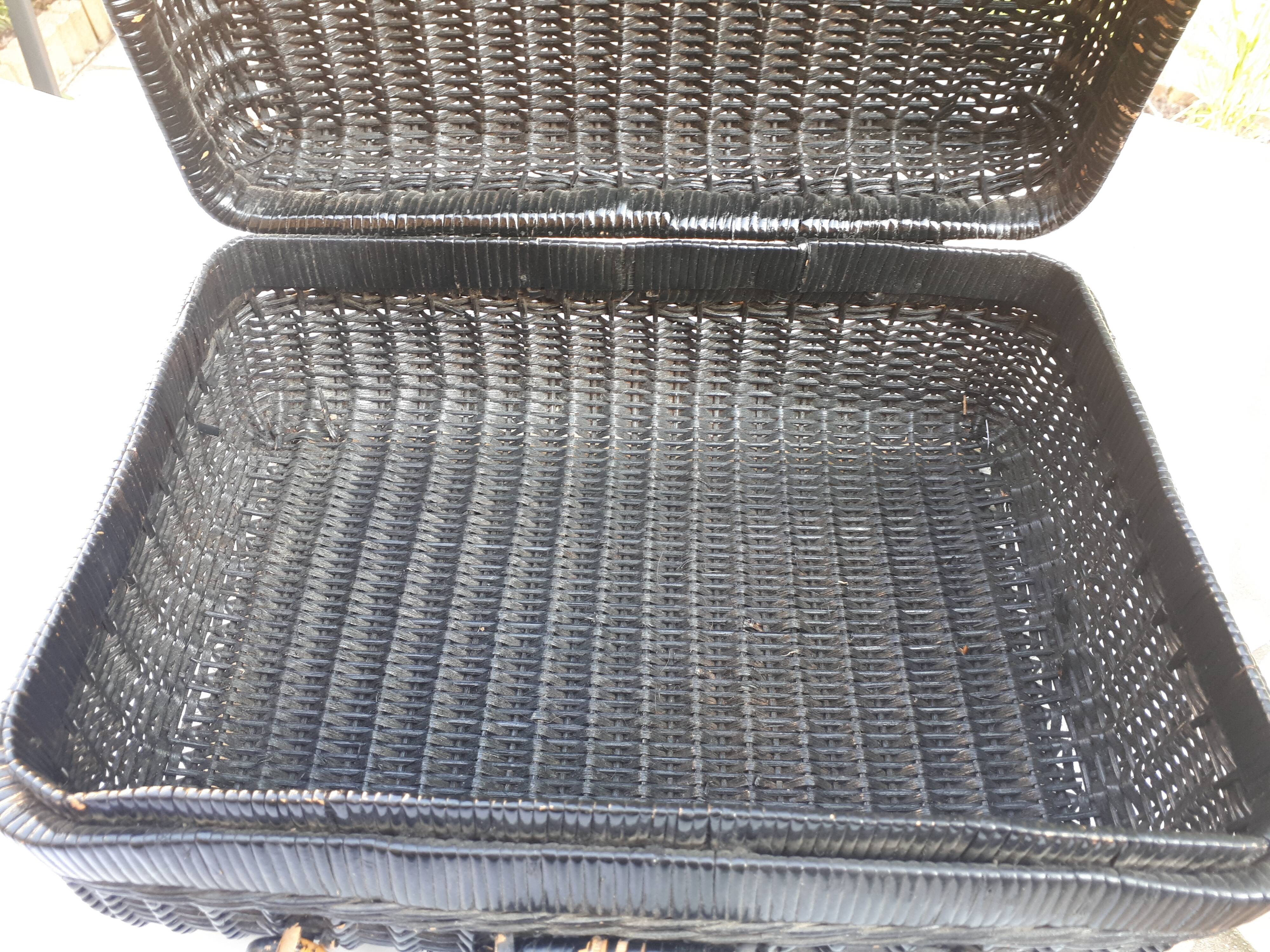 Old black wicker suitcase