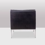 Pair of armchairs in black leather and chrome metal. 1970s.