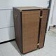 Wardrobe trunk on casters in mahogany and woven rattan.