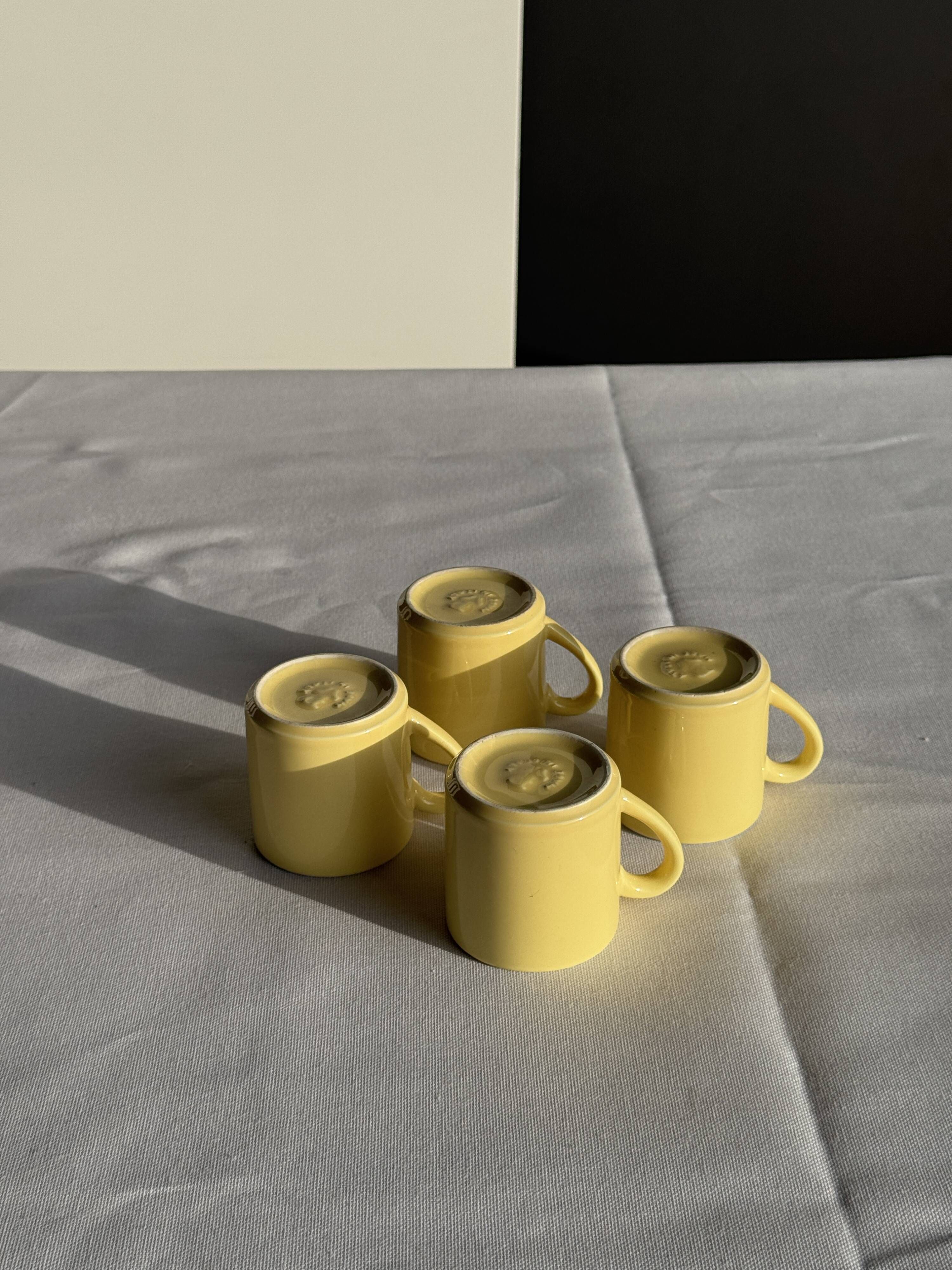 Set of 4 vintage yellow Italian espresso cups and saucers.