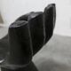 Black armchair chair in carved wood in the shape of a hand