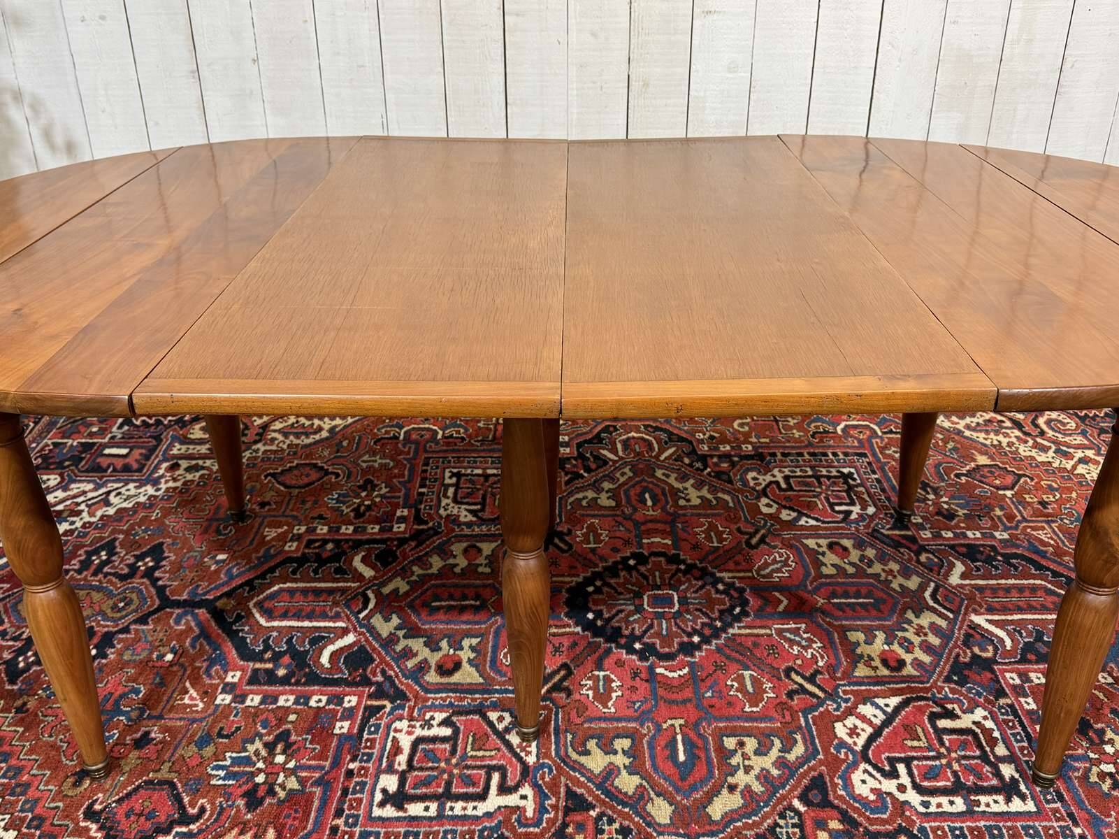 Round cherry wood table, 6 feet, Louis Philippe style with 2 extensions.