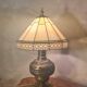 brass and bronze lamp with an antique base from 1900 and a glass paste shade