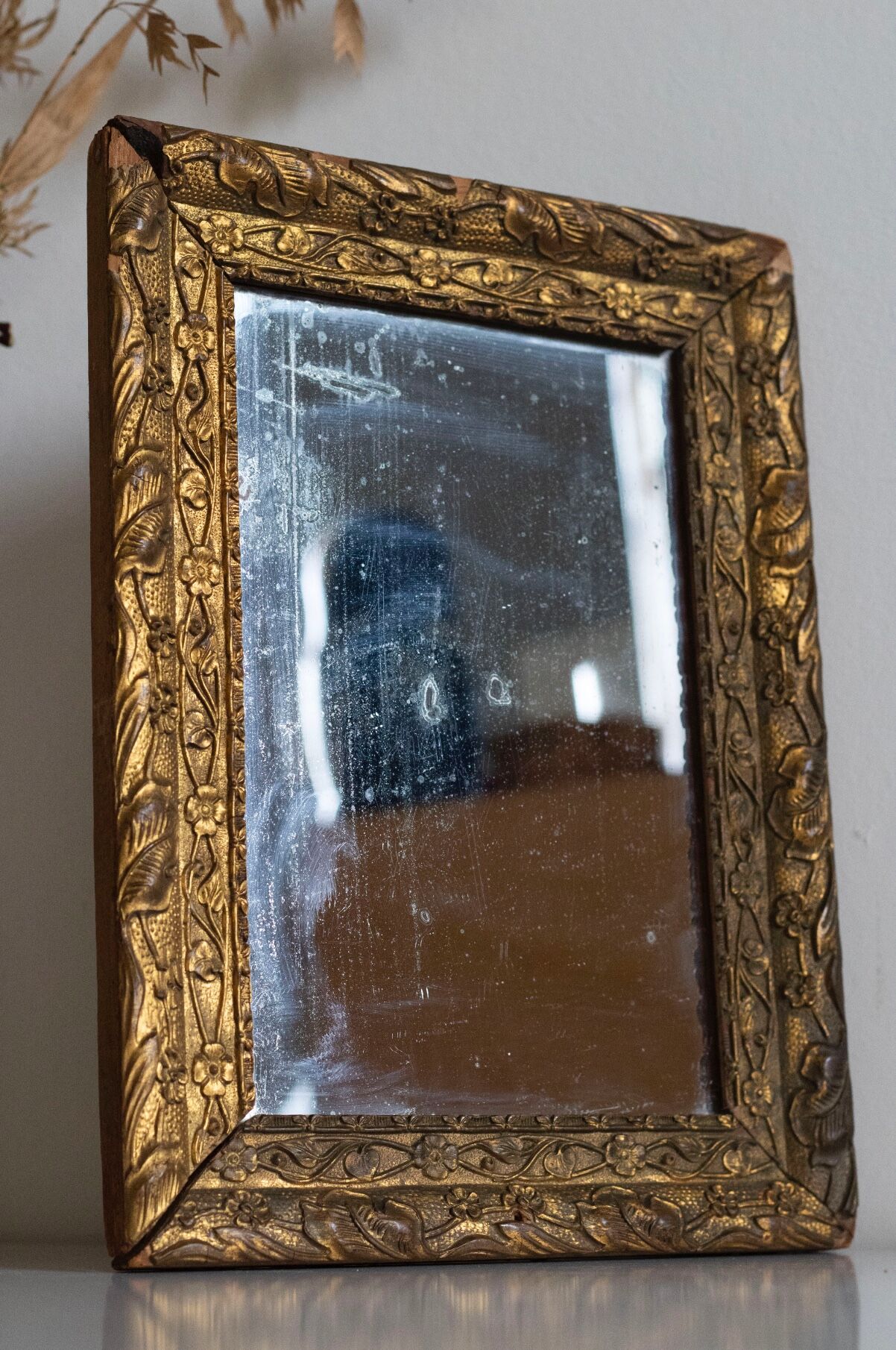 Antique mirror in gilded wood