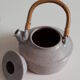 Set of sandstone teapot with rattan handle and six bowls from the 70s