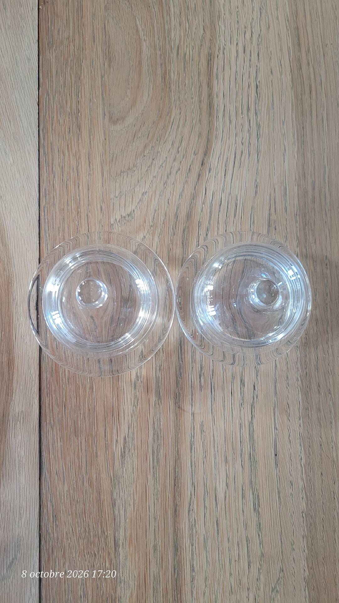 2 transparent glass butter dishes with their matching cloches.