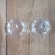 2 transparent glass butter dishes with their matching cloches.