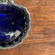 Vintage silver-plated shell butter dish with blue bowl.