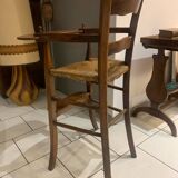 Antique straw-covered high chair
