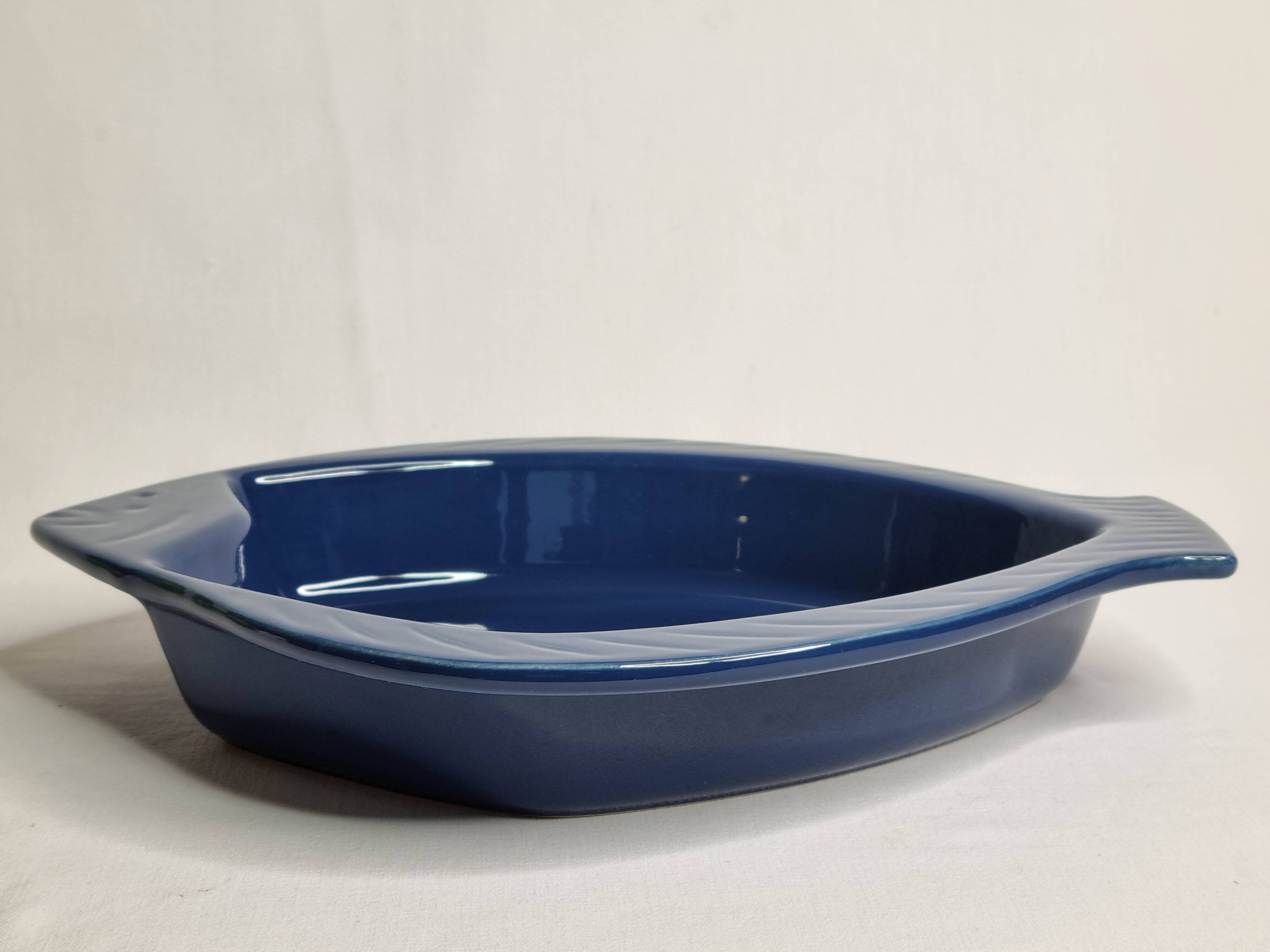 Blue ceramic serving dish in the shape of a fish signed Émile Henry