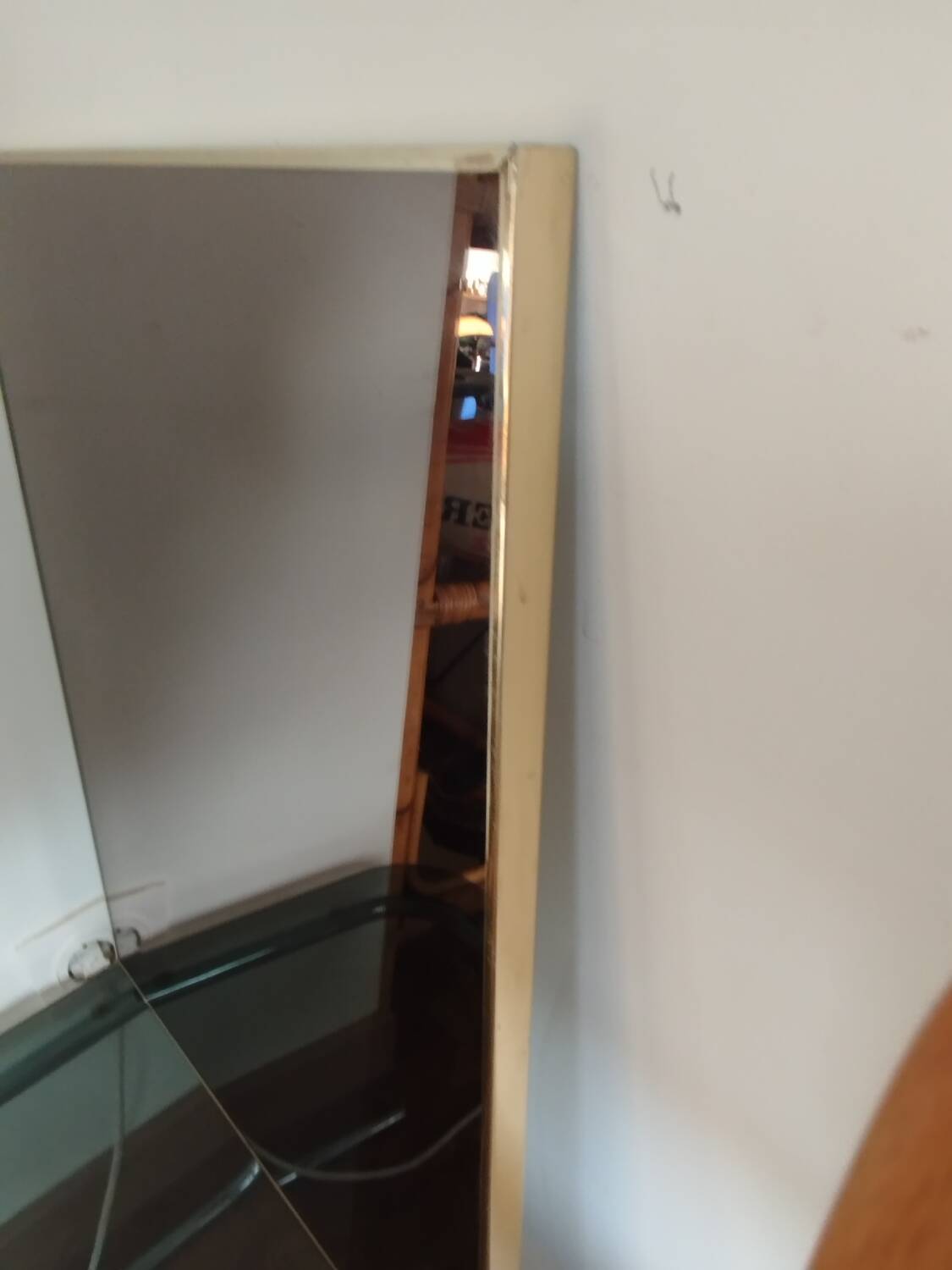 Vintage mirror in gilded brass and smoked glass. circa 1970