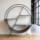 Round shelf on a stand in industrial style made of steel.