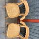 Pair of curved wooden bistro chairs with armrests