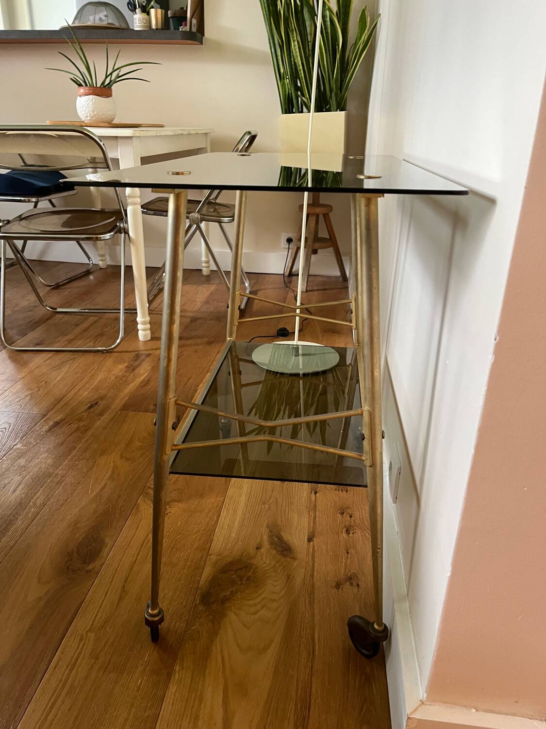 Vintage brass and smoked glass dessert trolley on wheels.