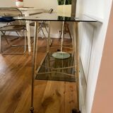 Vintage brass and smoked glass dessert trolley on wheels.
